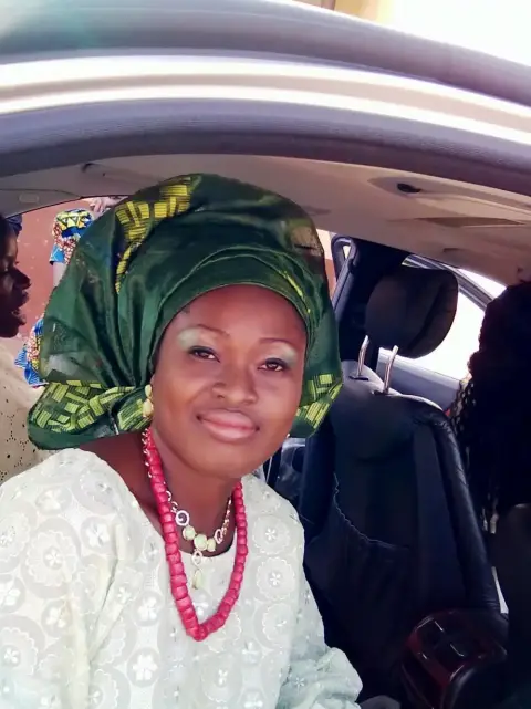 A Yoruba bride in a lace buba, coral beads and a gele made from aso-oke